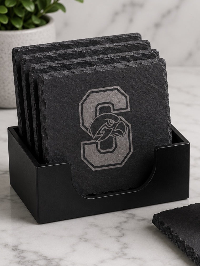 Four Seminole Ridge slate coasters laser-engraved with the Hawks S logo, standing in a black coaster holder