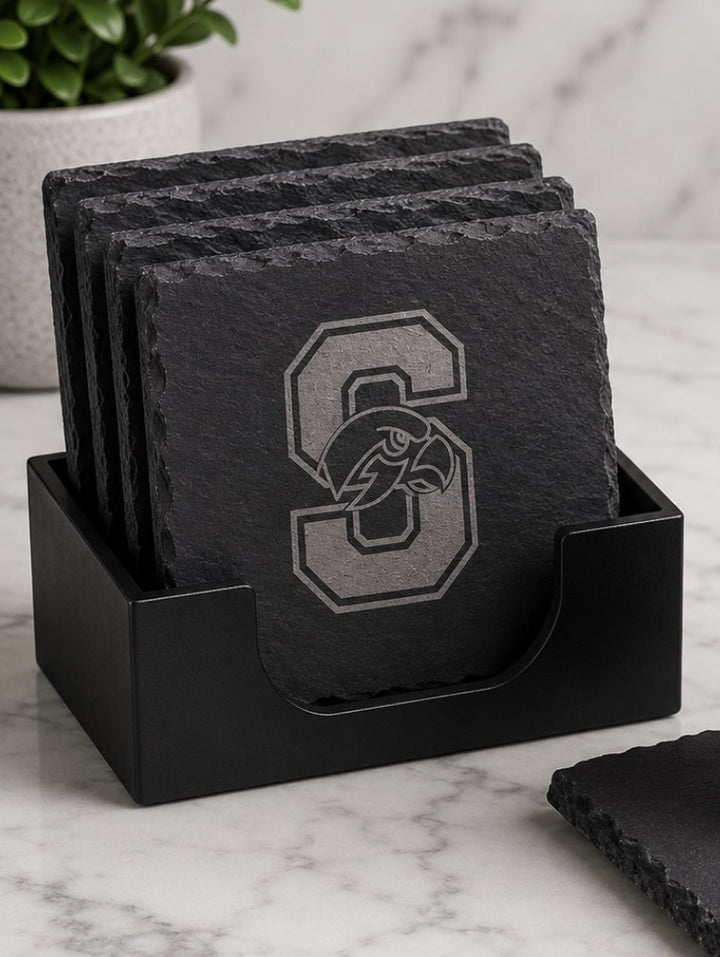 Four Seminole Ridge slate coasters laser-engraved with the Hawks S logo, standing in a black coaster holder